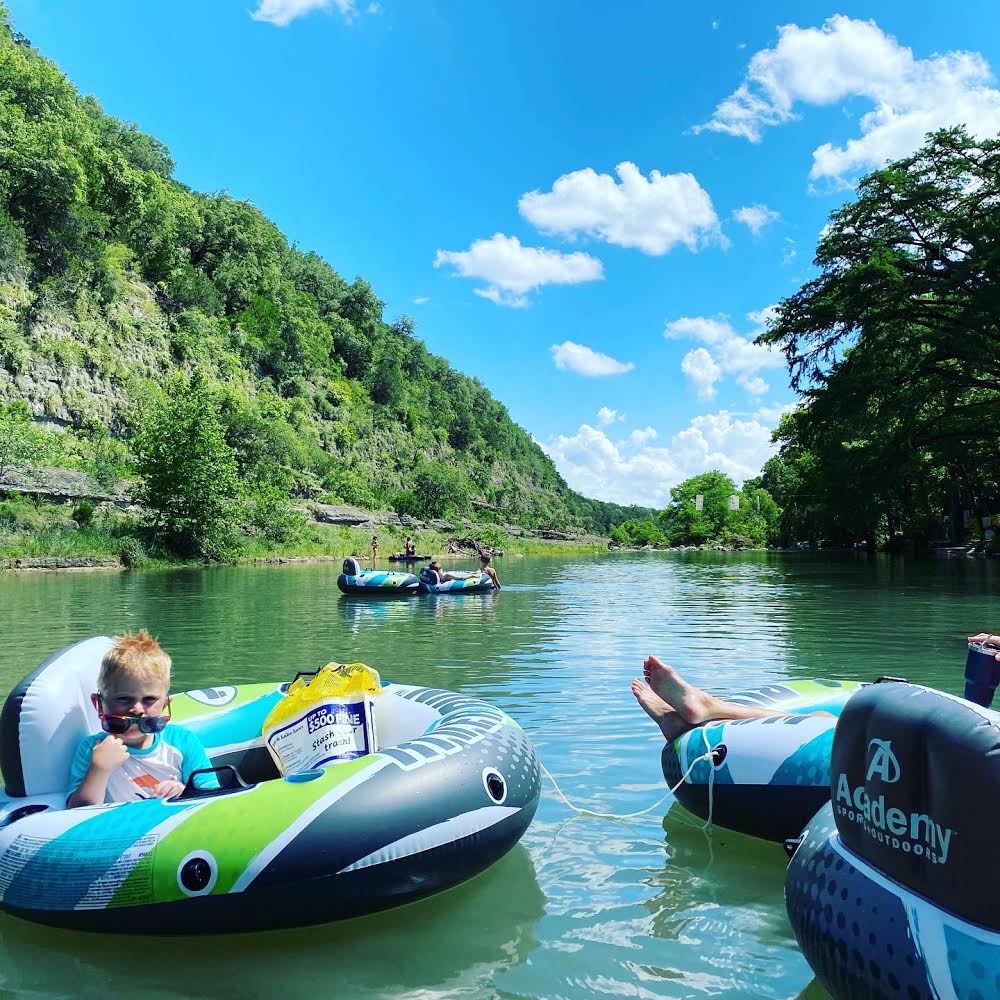 Kid tubing on the calm Guadalupe River near New Braunfels