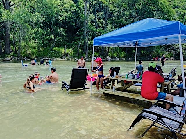 Families enjoying the river at the cabana
